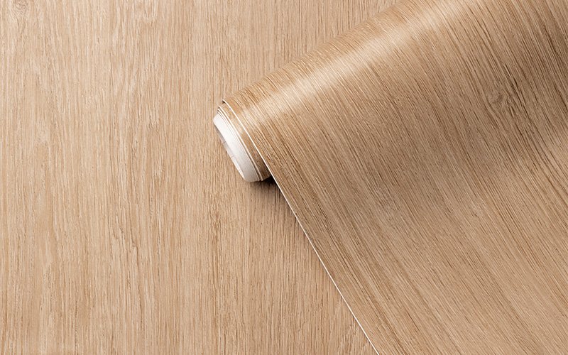 Close-up roll of wood laminate flooring requiring safe cleaning.