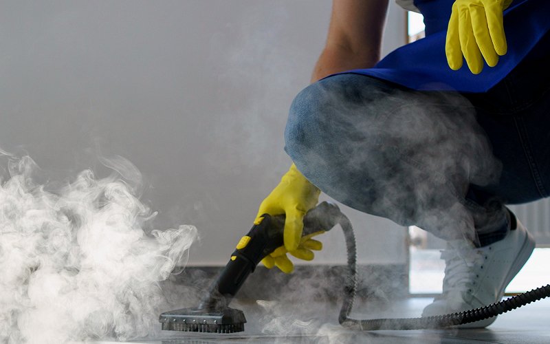 Using a steam cleaner for a professional deep cleaning service.