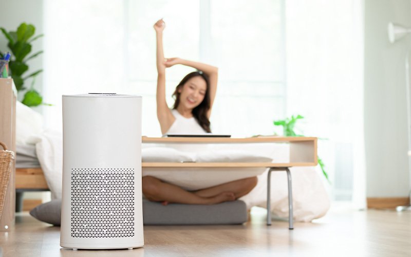 Air purifier in modern bedroom setting.