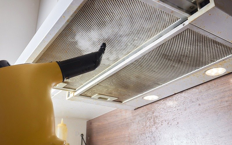 Cleaning a residential cooker hood mesh filter using steam